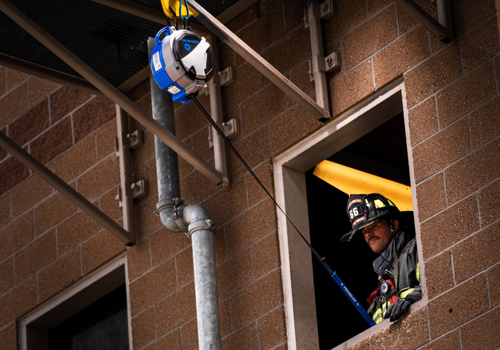 Firefighter using TruBlue SafeLine compared to a self-retracting lifeline during training