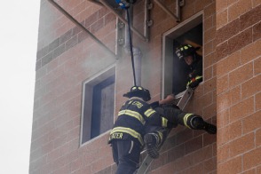 Firefighter lowering a victim using TruBlue SafeLine during a rescue training evolution