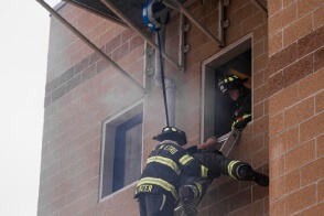 Firefighter lowering a victim using TruBlue SafeLine during a rescue training evolution