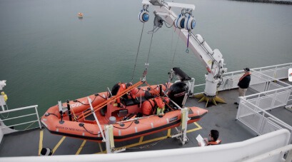 Crew performing boat launch drills with TruBlue SafeLine during maritime training