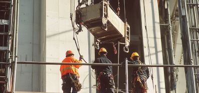 A team works on an elevated platform while protecting a large rigged asset, and those below, with TruBlue SafeLine