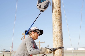 Many lineworker training poles equipped with TruBlue SafeLines near the top